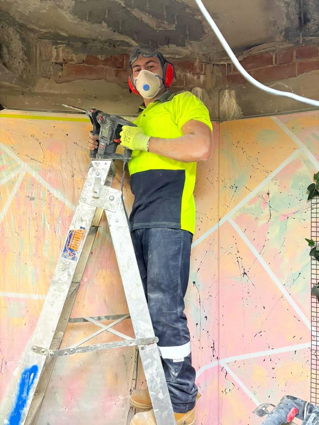 Crew member on a ladder during a fit-out job